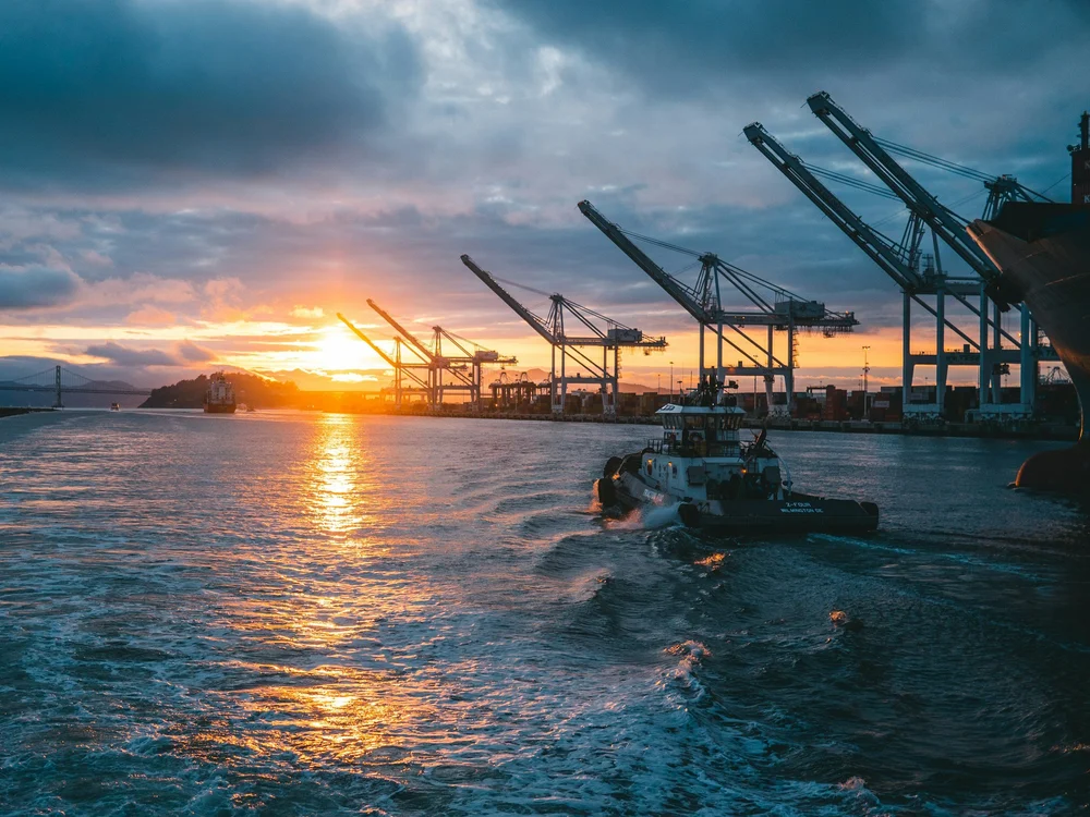 Container cranes at a working port at sunset